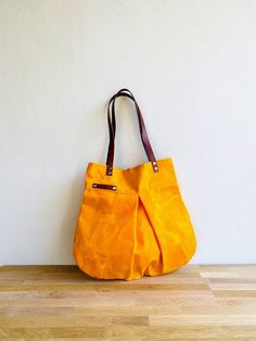 Cheap Orange Canvas Shoulder Bag, Cheap Orange Canvas Travel Bag, Cheap Yellow Canvas Bag With Adjustable Strap, Cheap Yellow Canvas Travel Bag, Daily Use Waxed Canvas Shoulder Bag With Pockets, Everyday Yellow Canvas Bag, Everyday Orange Bags With Pockets, Practical Everyday Shoulder Bag With Waxed Finish, Orange Canvas Bag For Everyday Use