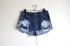 Levi's 557 denim shorts*Classic high waisted fit*Dark blue denim*Ripped, frayed and a bit cuffed*Handmade - this makes them one of a kindSize: Small / W29 from tagMeasurements (centimeters and inches)Waist: 74 cm / 29 inchesHips: 90,5 cm / 35,5 inchesRise: 31 cm / 12,25 inchesInseam: 3 cm / 1 inchesTake a look at other denim shorts from my shop:https://www.etsy.com/shop/sisudenimstore?section_id=21382979Sisu Denim is a part of Sisu Vintage Store, which you can find here:sisuvintagestore.etsy.com Dark Wash Ripped High Waist Shorts, Dark Wash Distressed Cutoff Jean Shorts, Grunge Ripped High-waisted Shorts, Grunge High-waisted Ripped Shorts, Ripped Dark Wash Denim Jean Shorts, Ripped Cutoff Dark Wash Shorts, Ripped Dark Wash Denim Shorts, Ripped Dark Wash High-waisted Jean Shorts, Ripped High-waisted Jean Shorts In Dark Wash