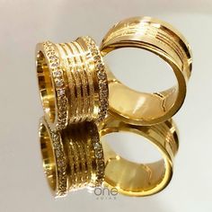 two gold rings with diamonds on them