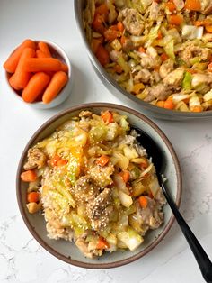 two bowls filled with food sitting next to each other on a white counter top near carrots