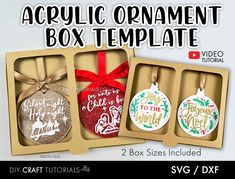 three christmas ornaments in cardboard boxes with ribbon