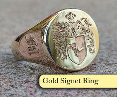 "At our store, we offer a range of exquisite \"Family Crest Ring\" and \"Coat of Arms Ring\" options that are fully customizable to capture the unique identity and history of your family. Family crests and coats of arms have been an essential part of family tradition for centuries, symbolizing the lineage and cultural significance of a family.  Our rings are meticulously crafted by skilled artisans, featuring your family crest or coat of arms engraved on a stunning gold or silver band, and adorn Luxury Wedding Engraved Intaglio Ring, Luxury Oval Signet Ring With Coat Of Arms, Pinky Signet Ring Family Crest, Luxury Heirloom Signet Ring With Coat Of Arms, Luxury Signet Ring With Coat Of Arms, Luxury Vintage Signet Ring With Coat Of Arms, Luxury Anniversary Signet Ring With Coat Of Arms, Luxury Engraved Ring With Coat Of Arms As Gift, Luxury Engraved Ring With Coat Of Arms