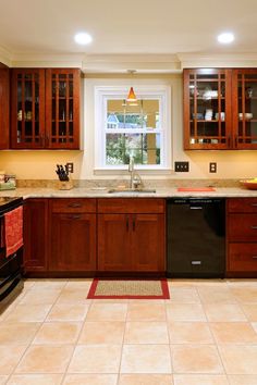 a kitchen with wooden cabinets and tile flooring