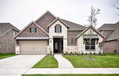 a large house with two garages in the front yard