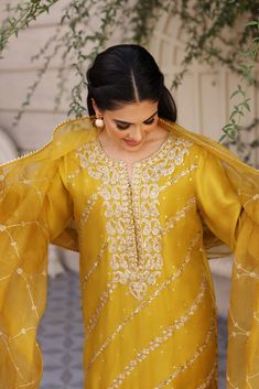 Gold Slub Silk Salwar Kameez With Resham Embroidery, Semi-stitched Yellow Kurta With Gota Work, Gold Slub Silk Kurta With Dupatta, Gold Slub Silk Sharara, Gold Slub Silk Sharara For Eid, Gold Salwar Kameez With Resham Embroidery In Slub Silk, Yellow Raw Silk Kurta With Traditional Drape, Yellow Slub Silk Churidar With Zari Work, Gold Slub Silk Sharara With Zari Work