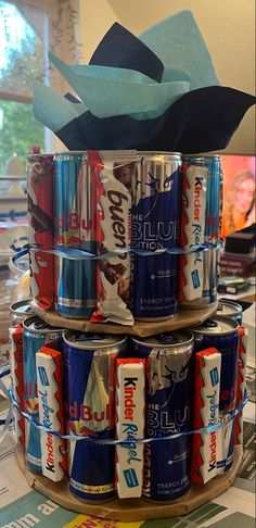 several cans stacked on top of each other with paper hats in the middle, and one can be used as an ornament