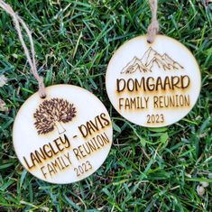 two personalized ornament hanging in the grass for family reunions to be placed on