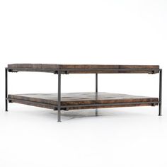 a wooden and metal coffee table on a white background with no one around it,