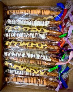 a box filled with different types of pretzels wrapped in plastic wrappers and ribbons