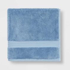 a blue towel is folded on top of a white wall and it's light blue