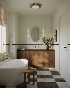 a large white bath tub sitting next to a sink in a bathroom on top of a black and white checkered floor