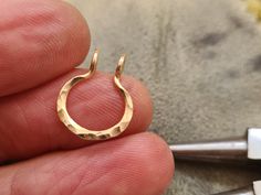 ❤️ NO PIERCING REQUIRED      Slightly hammered fake septum ring ► Please choose material: 100% 14K gold filled 100% Silver Sterling  Inner diameter: 8 mm approx. Gauge (wire thickness) 18g ♥ Dear buyer just for knowledge: HOW TO PUT IT ON? 1.Gently open the cuff . 2.Position the cuff around your nasal septum 3.Firmly pinch the cuff with your fingers. 4.Make sure it stay in the place WHAT IS GOLD FILLED? Gold filled is an actual layer of gold-pressure bonded to another metal. It does not flake of Fake Septum Ring, Faux Septum Ring, Nasal Septum, Fake Nose Ring, Faux Septum, Septum Hoop, Septum Nose Rings, Fake Nose Rings, Fake Nose