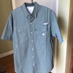 Columbia Polo Shirt Pfg Size Small New Without Tags Mesh Lined Short Sleeve 4 Front Pocket With Velcro Button Front Shoulder To Shoulder 20” Armpit To Armpit 23” Sleeve 10” Length 31” 100 % Cotton Casual Long Sleeve Camp Shirt With Button Closure, Khaki Short Sleeve Button-up Shirt, Outdoor Button-up Tops With Functional Buttons, Button-up Tops With Pockets For Outdoor, Collared Outdoor Tops With Pockets, Green Buttoned Tops For Outdoor, Spring Long Sleeve Camp Shirt With Buttons, Khaki Short Sleeve Shirt With Button Closure, Spring Long Sleeve Camp Shirt