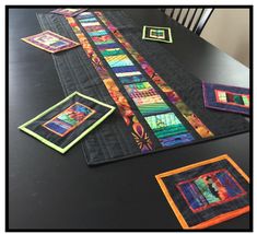 the table is covered with quilts and pictures