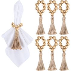 six pieces of gold beaded tassels and two white napkins with bows