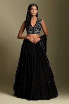 Black crepe blouse with V neck, all over sequin, cut dana, moti, pearls and 3D resham thread embroidery. Paired with georgette pleated lehenga with butti pattern embroidery and dupatta with zari work scalloped cut work dupatta.
Component: 3
Pattern: Embroidered
Type Of Work: Sequin, Cut Dana, Moti, Pearls, Zari and 3D Resham Work
Neckline: V Neck
Sleeve Type: Sleeveless
Fabric: Georgette, Blouse: Crepe
Color: Black
Other Details: 
Embroidered dupatta
Fringe tassel details on dupatta
Closure:
Leh Blouse Lehenga, Black Lehenga, Floral Print Sarees, Set Saree, Saree Gown, Embroidered Lehenga, Designer Outfits, Silk Lehenga, Lehenga Designs