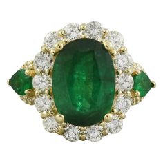 Introducing our stunning 6.00 Carat Natural Emerald Ring crafted in luxurious 14K Solid Yellow Gold. This exquisite piece features a captivating center emerald weighing 3.90 Carats, cut in an elegant oval shape measuring 12.00x10.00 millimeters. Complementing the center stone are two pear-shaped side emeralds, totaling 0.20 Carats, adding a touch of sophistication to the design. Adorned with sparkling diamonds weighing 1.90 carats, boasting a delightful F-G color and VS2-SI1 clarity. With a total ring weight of 7.6 grams, this masterpiece showcases a face measuring 17.60x14.65 millimeters. Stamped for authenticity, this ring is a timeless symbol of elegance and refinement. 6.00 Carat Natural Emerald 14K Solid Yellow Gold Diamond Ring Stamped: 14K Total Ring Weight: 7.6 Grams Center Emerald Natural Emerald Rings, Yellow Gold Diamond Ring, Emerald Diamond Ring, Gold Diamond Ring, Ring Crafts, Pear Shaped Diamond, Emerald Jewelry, Gold Diamond Rings, Natural Emerald