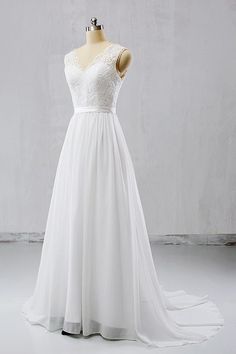 a white wedding dress on a mannequin with lace and chiffon overlay