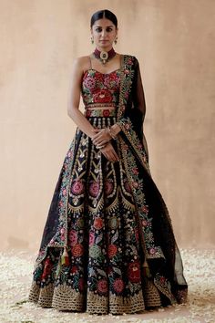 Black lehenga with foliage vintage pattern, multicolor thread, sequin, bead and cutdana embroidery. Paired with sleeveless embroidered blouse and dupatta with embroidered border. Components: 3 Pattern: Embroidery Type Of Work: Thread, sequin, bead, cutdana, floral Neckline: Sweetheart neck Sleeve Type: Sleeveless Fabric: Raw Silk, Organza Color: Black Other Details:  Cutwork hem Border embroidered sheer dupatta Crystal drops on blouse hem Model height: 5ft 9inches, wearing size S Note: Necklace Floral Embroidery Lehenga, Floral Thread Embroidery, Embroidery Lehenga, Raw Silk Lehenga, Black Lehenga, Indian Bridal Outfits, Silk Lehenga, Black Thread