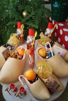 a table topped with lots of different types of christmas decorations and candies on top of it