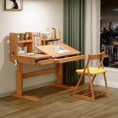 a wooden desk with a chair next to it in front of a window and cityscape