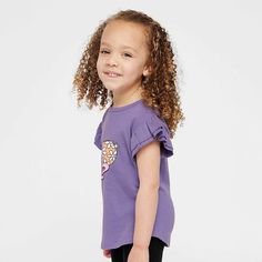 Looking for a cute tee for your daughter? We have the perfect flutter sleeve graphic tee. Cute Purple Top With Ruffles, Cute Summer T-shirt With Ruffle Sleeves, Purple Flutter Sleeve Top For Summer, Lavender Short Sleeve Tops With Ruffles, Lavender Tops With Ruffles And Short Sleeves, Playful Cotton Top With Flutter Sleeves, Playful Cotton Tops With Flutter Sleeves, Cute Crew Neck T-shirt With Ruffles, Cute Lavender Cotton Top