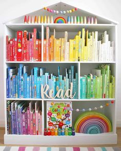 a book shelf filled with lots of books and crayons on top of it