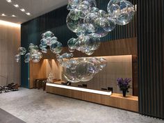 the lobby is decorated with large bubbles floating in the air and flowers on the counter