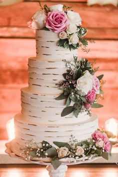 a white wedding cake with pink and white flowers