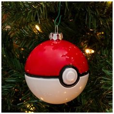 a red and white ornament hanging from a christmas tree