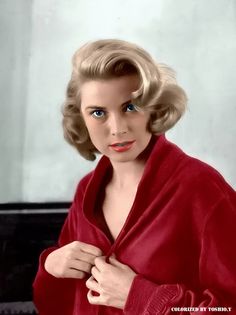 a woman in a red robe is posing for a photo