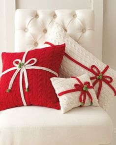 red and white pillows with bows on them