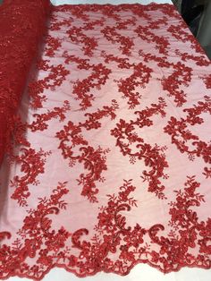 a red table cloth with flowers on it