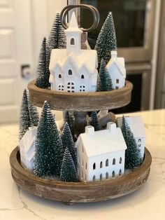 three tiered trays with houses and trees on them