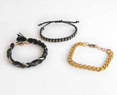 Black bracelet set is very versatile as it goes well with many different outfits. It looks great with black or golden watch, but each of the bracelets can be worn separately too. This is set of three bracelets in black and gold color combination. Stack has these bracelets:- macrame bracelet with brass beads and sliding knot at the back- golden colored aluminum chunky chain (does not change color) bracelet which closes with lobster clasp- braided bracelet made from soft cotton and faux leather co Edgy Bracelets With Adjustable Chain, Black Metal Wrap Bracelet For Gift, Trendy Black Metal Chain Bracelet, Trendy Gold Wrap Bracelet, Handmade Black Metal Braided Bracelets, Handmade Metal Braided Bracelets In Black, Trendy Black Chain Bracelet Gift, Trendy Adjustable Black Chain Bracelet, Trendy Black Chain Bracelet For Party