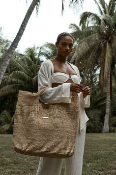 The carry it all bag The Paloma Bag was thoughtfully designed to carry everything you might want for your oceanside tanning session. This bag’s texture instantly elevates any outfit and can effortlessly transition from sand to city in a blink of an eye.Features:Hand crocheted of natural grass yarnsLight weightGold logo Monday Swimwear, Chevron Fabric, Beach Wear Dresses, Signature Collection, Paloma, Recycled Fabric, Large Bags, Hand Crochet, Straw Bag