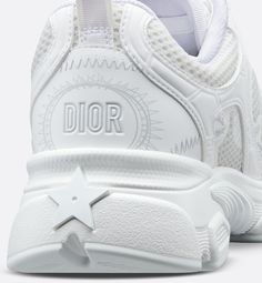 The Dior Chrono sneaker revisits the running shoe with the House's couture codes. Pairing mesh with white leather-effect panels, it is accented by hallmark detailing like the CD signature on the sides, a star patch on the tongue and a rear Dior signature. Featuring two-tone laces and an ultralightweight sole adorned with a star, the sneaker will complete laid-back outfits year-round.. Laid Back Outfits, Denim Swimsuit, Dior Star, Dior Sneakers, Icon Shoes, Ballerina Pumps, Dior Book Tote, Mens Travel Bag, Short Denim