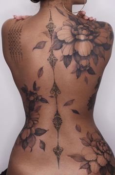 the back of a woman with tattoos on her body