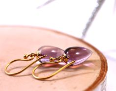 "Inverted teardrops in gorgeous purple amethyst are just so pretty. This upside down gemstone style is very high end and this pair is set with gold vermeil peg and cup style findings and hung from small vermeil wires. Awesome addition to your jewelry collection, very feminine, and a great gift for all ages. Stone is 8x12mm, earrings measures 1.25 inches. return to shop all items: http://www.etsy.com/shop/amyfine ask me anything you like here: http://www.etsy.com/convo_new.php?to_username=amyfine Purple Gemstone Teardrop Earrings, Handmade Amethyst Teardrop Earrings, Teardrop Amethyst Earrings As Gift, Amethyst Teardrop Earrings For Gift, Teardrop Amethyst Earrings For Gift, Gift Amethyst Teardrop Earrings, Teardrop Purple Earrings With Natural Stones, Purple Teardrop Earrings With Natural Stones, Amethyst Gemstone Teardrop Earrings Gift