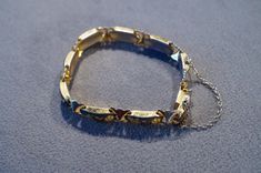 I am offering this fabulous vintage yellow gold tone bracelet. This piece is truly gorgeous, and it has the following features: * beautiful vintage bracelet * line link * enameled * jet black * floral design * stackable * 7 inches in length This is a fantastic and classic piece. There is tons of sparkle and shine with this piece. It will beautifully complement your upcoming fashion season. Buyer pays all shipping and handling. Design Line, Stud Style, Vintage Bracelet, Rhinestone Studs, Genuine Turquoise, Enamel Jewelry, Fashion Seasons, Vintage Bracelets, Wedding Bracelet