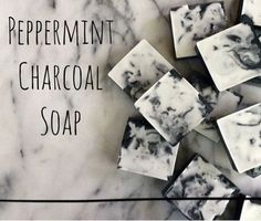 several pieces of soap sitting on top of a white marble counter with the words peppermint and charcoal soap