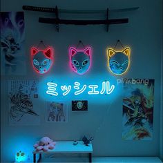 three neon signs are hanging on the wall above a desk with a stuffed animal and other items