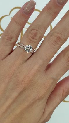 a woman's hand with a diamond ring on it