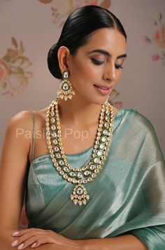 Inspired by traditional Indian jewelry, our Kundan necklace set is a masterpiece beautifully handcrafted by the artisans of India to balance the new traditions with old-world beauty. The bold and bright design of the green Kundan necklace is perfect for the woman of today, who loves to celebrate beauty with heritage. Make your mark by adding this unblemished necklace to your bridal trousseau. Necklace Closure - Adjustable Dori Earring Closure - Pushback Style Tip - A perfect pair for someone who Traditional Chandbali Pearl Necklace For Formal Occasions, Traditional White Hand Set Jewelry, Traditional Temple Necklace For Formal Occasions, Traditional White Hand-set Jewelry, White Kundan Temple Necklace For Ceremonial Occasions, Traditional Necklaces Hand Set For Celebrations, Traditional Kundan Temple Necklace For Formal Occasions, Traditional Kundan Temple Necklace For Formal Events, White Meenakari Fusion Necklaces