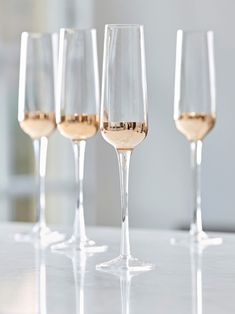 five wine glasses lined up on a table