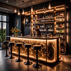 a dimly lit bar with stools in front of it