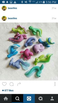 there are many small toy animals on the table together, including one dolphin and two dolphins