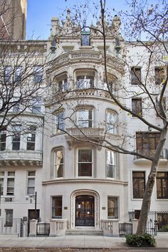 a large white building with many windows and balconies