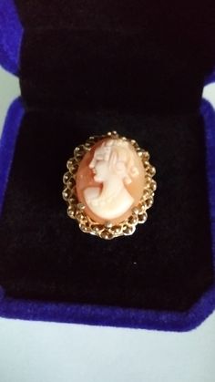 "Thanks for stopping by my shop BoHoCoDeco. I'm excited to offer the wonderful one of a kind finds that you will cherish. Please visit BoHoCoDeco often to see what else is being offered. This vintage coral and ivory-colored cameo is in a six prong setting of 10K gold. The figure is facing left and has curls reaching down her neck. The gold setting has a open weave designed gallery and a filagree frame around the cameo. Size: 6.5 Weighs: 4.2 g. Stamped: 10K There are no visible cracks or chips. S Victorian Cabochon Rings As Gifts, Victorian Cabochon Rings For Gift, Victorian Cabochon Rings As A Gift, Victorian Cameo Rings As Gift, Victorian Oval Cabochon Rings For Gift, Victorian Carved Rings For Gifts, Victorian Carved Rings As Gift, Victorian Carved Rings Ideal For Gifts, Yellow Gold Cameo Rings For Gifts