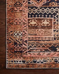 an area rug with various colors and patterns on it, including brown, blue, pink, orange and black